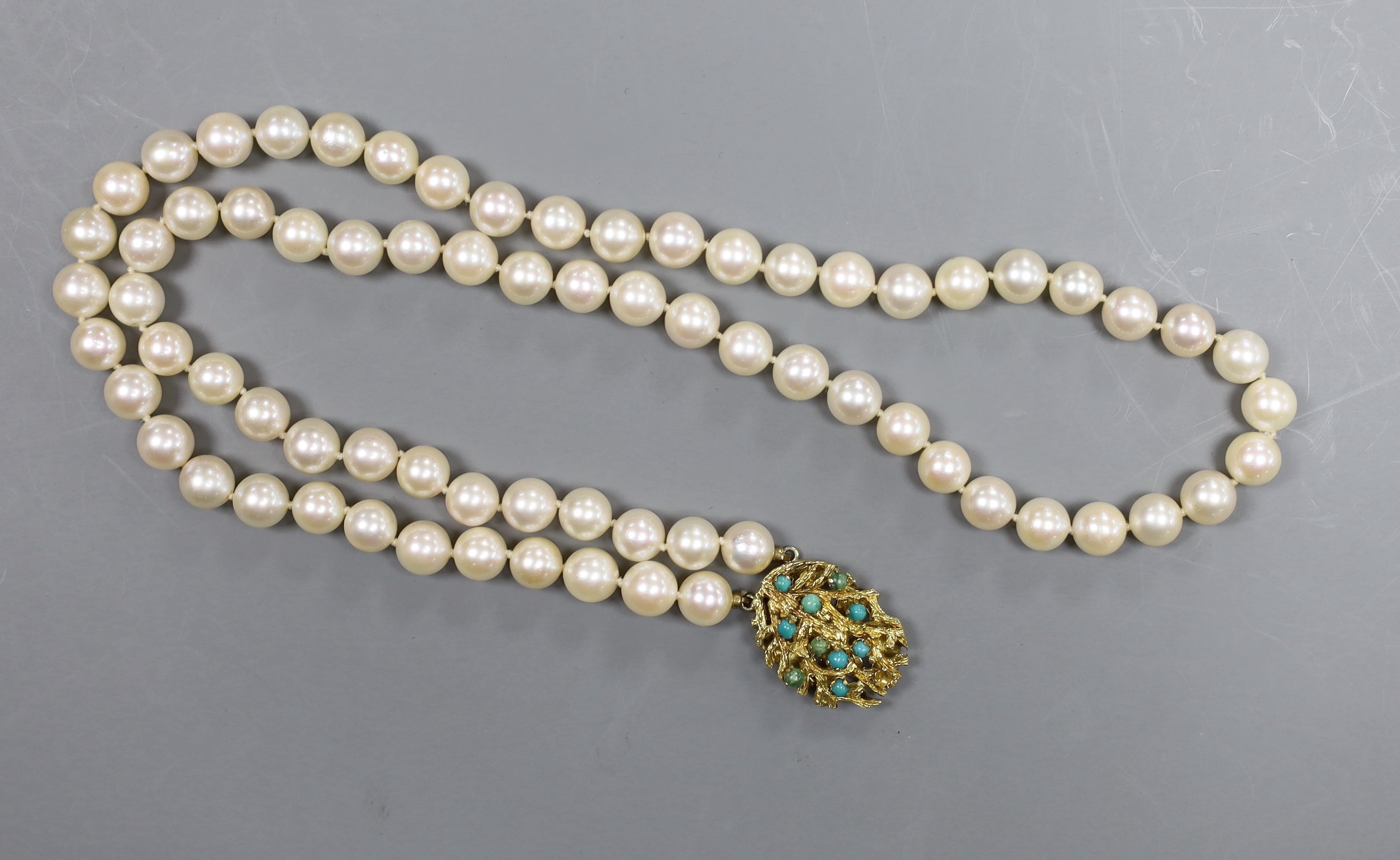 A two strand cultured pearl necklace with 14ct gold and turquoise set clasp, 33cm